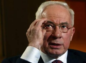 Ukrainian Prime Minister Azarov adjusts his glasses during an interview at World Economic Forum in Davos